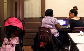 A student at Queens University of Charlotte works on digital literacy skills with a Charlotte resident at Grier Heights Community Center, April 2017.
